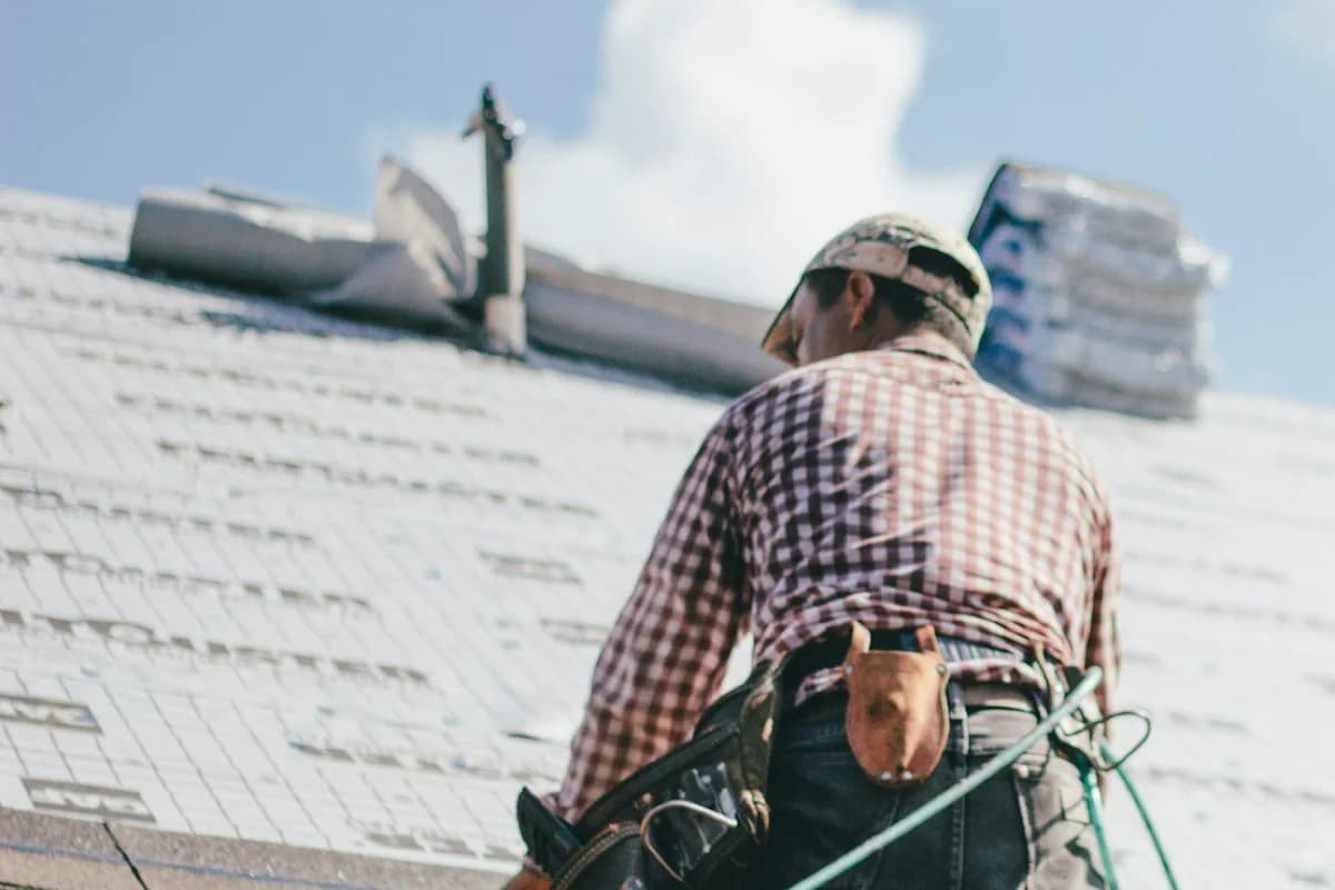 Professional roofing contractor installing shingles on Lowcountry home